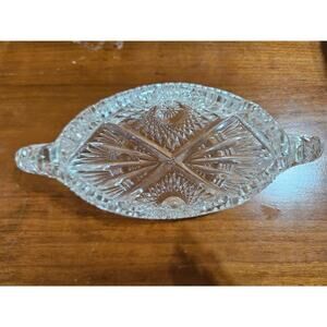 Cut glass relish tray with saw tooth design and finger loops.